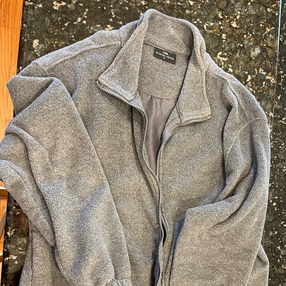 Men’s size medium gray fleece jacket. The back is decorated with Alaskan design.
